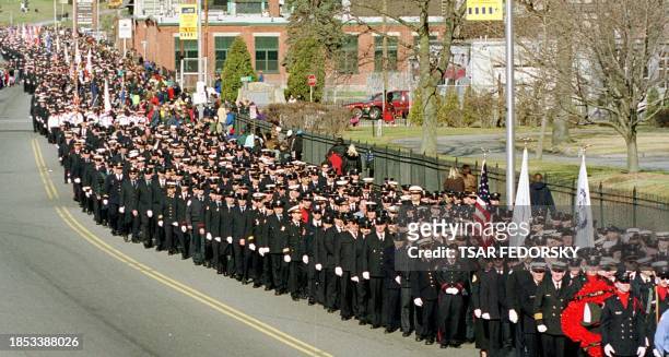 Thousands of firefighters from around the US march in a procession in downtown Worcester, Massachusetts 09 December, 1999 honoring the six Worcester...