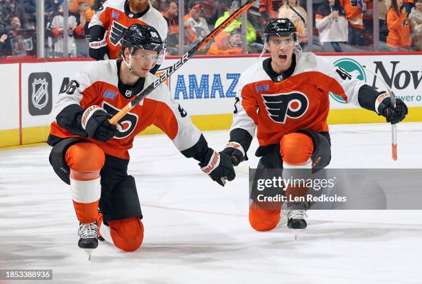 Joel Farabee and Morgan Frost of the Philadelphia Flyers skate during warmups prior to their game against the Detroit Red Wings at the Wells Fargo...
