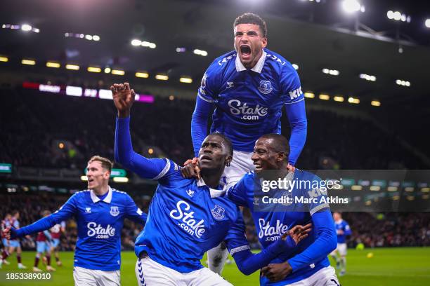 Amadou Onana of Everton celebrates with Abdoulaye Doucoure and Ben Godfrey after scoring their team's first goal during the Premier League match...