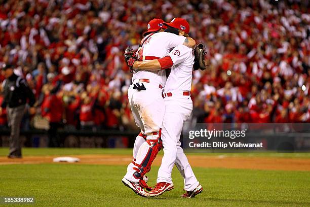 Trevor Rosenthal and catcher Yadier Molina of the St. Louis Cardinals celebrate after the Cardinals defeat the Los Angeles Dodgers 9-0 in Game Six of...