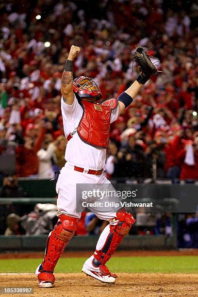 Yadier Molina of the St. Louis Cardinals celebrates as Mark Ellis of the Los Angeles Dodgers strikes out as the Cardinals defeat the Los Angeles...