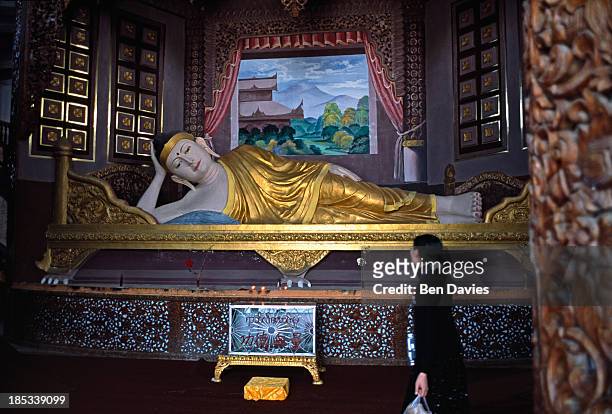 Reclining Buddha inside a temple in Mongla, a remote town on the border with China..