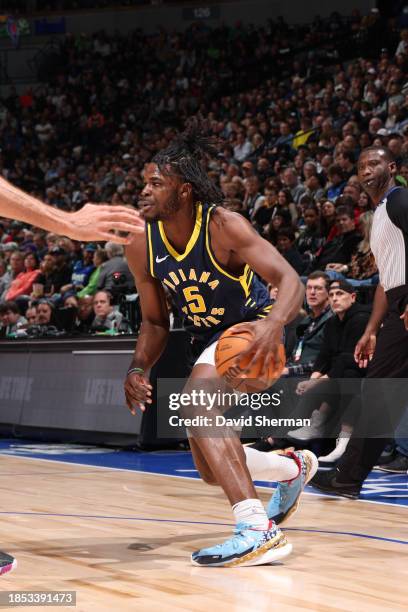 Jarace Walker of the Indiana Pacers handles the ball during the game against the Minnesota Timberwolves on December 16 , 2023 at Target Center in...