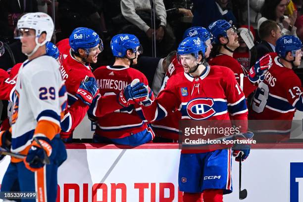 Montreal Canadiens right wing Josh Anderson celebrates his second goal of the game with his teammates at the bench during the New York Islanders...