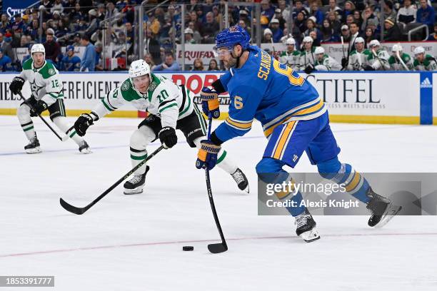 Ty Dellandrea of the Dallas Stars pressures Marco Scandella of the St. Louis Blues on December 14, 2023 at the Enterprise Center in St. Louis,...