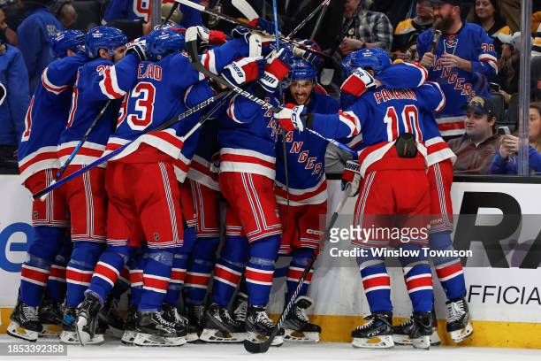 The New York Rangers mob teammate Vincent Trocheck after he scored the game-winning goal during the overtime period against the Boston Bruins at TD...