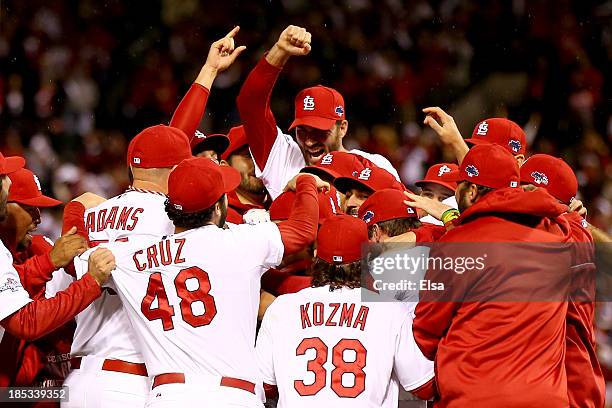 The St. Louis Cardinals celebrate after defeating the Los Angeles Dodgers 9-0 in Game Six of the National League Championship Series at Busch Stadium...