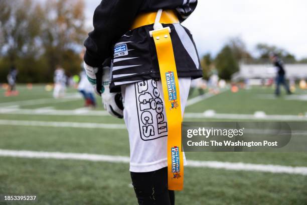 Player for the Beavercreek Raiders, a flag football team, stands on the sidelines during a game in Dayton, Ohio on October 8, 2023.