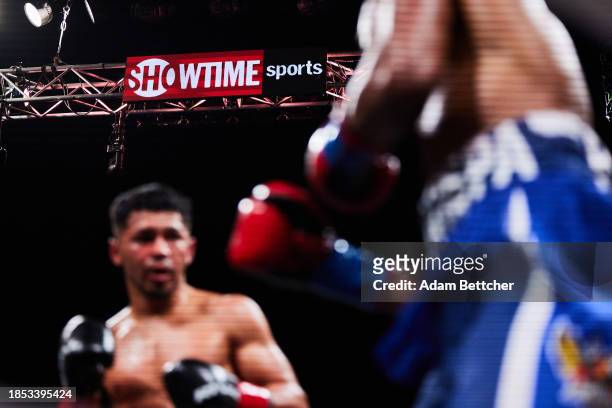 Boxers fight below the Showtime Sports logos before the undefeated WBA Super Middleweight Champion David Morrell Jr. And Sena Agbeko bout at The...