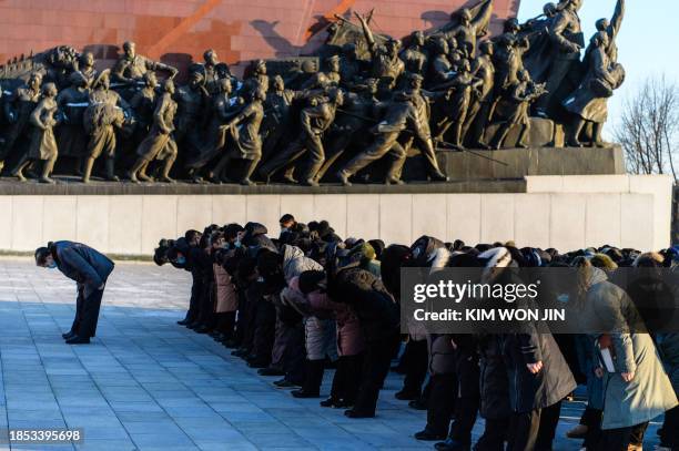 People visit Mansu Hill to pay their respects in front of statues of late North Korean leaders Kim Il Sung and Kim Jong Il, to mark the twelfth...