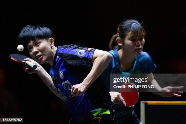 Taiwan's Cheng I-Ching serves the ball with Li Yu-Jhun to Japan's Miyuu Kihara and Miyu Nagasaki during their women's doubles semi-final table tennis...