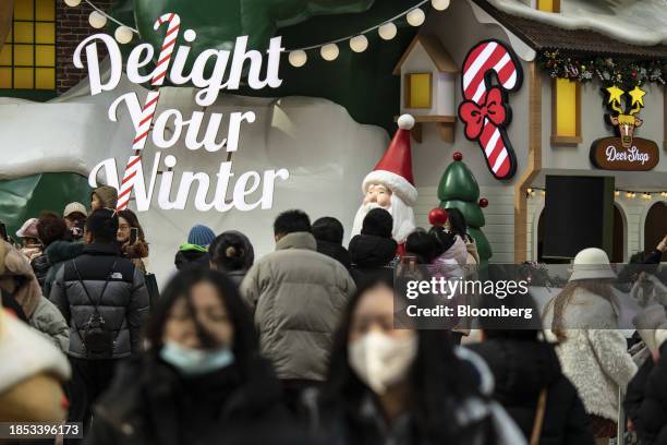 Weekend shoppers browse through a Christmas-themed market outside an upscale shopping mall in Shanghai, China, on Sunday, Dec. 17, 2023. China's...