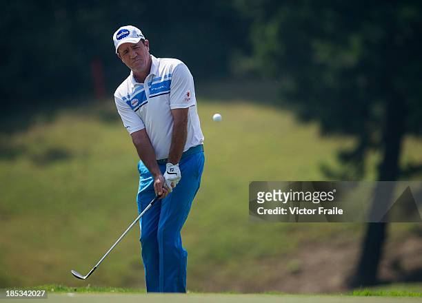 Scott Hend of Australia chips into the 5th green during day three of the Venetian Macau Open at Macau Golf and Country Club on October 19, 2013 in...