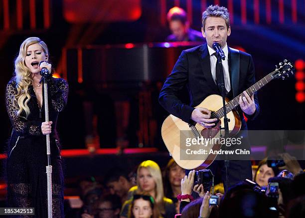 Avril Lavigne and Chad Kroeger performing on We Day at Rogers Arena on October 18, 2013 in Vancouver, Canada.