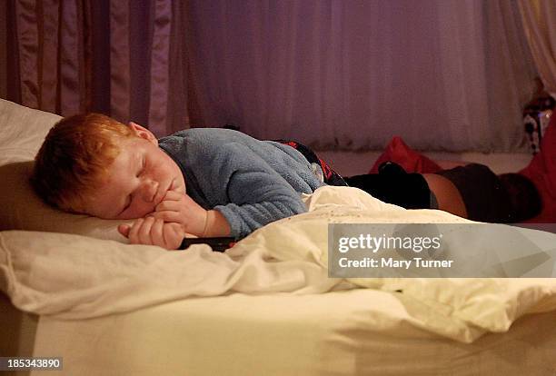 Dennis Sheridan sleeps in his family's trailer on the road outside the Dale Farm site on October 18, 2013 in Crays Hill, England. Two years on from...