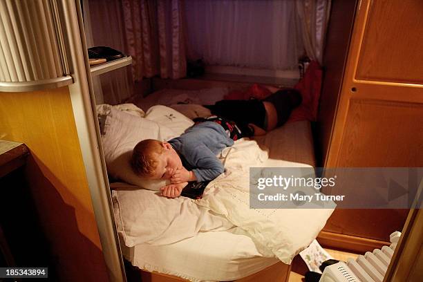 Dennis Sheridan sleeps in his family's trailer on the road outside the Dale Farm site on October 18, 2013 in Crays Hill, England. Two years on from...