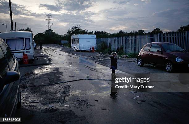 Young child walks up the road leading to the Dale Farm site, where she and her family now live on October 18, 2013 in Crays Hill, England. Two years...