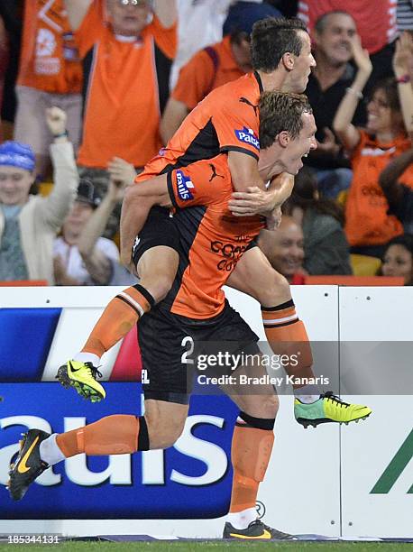 Matthew Smith and Liam Miller of the Roar celebrate a goal during the round two A-League match between Brisbane Roar and Sydney FC at Suncorp Stadium...