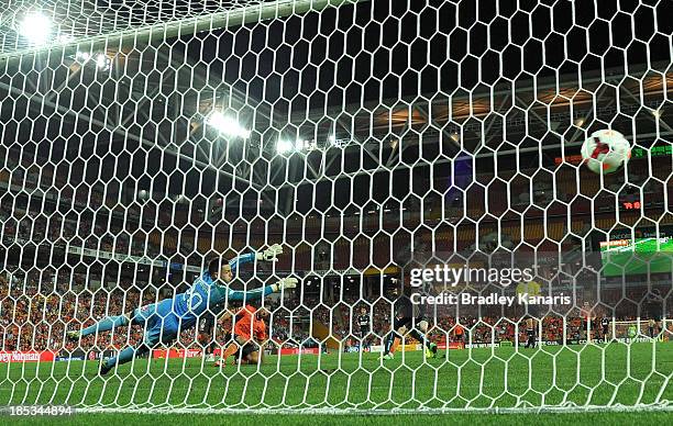 Thomas Broich of the Roar scores a goal as Ivan Necevski of Sydney dives in an attempt to save the goal during the round two A-League match between...