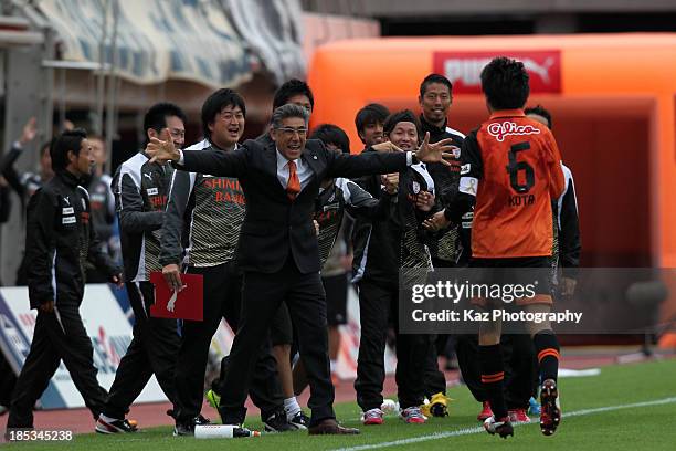 Kota Sugiyama of Shimizu S-Pulse is congratulated by head coach Afshin Ghotbi after scoring his team's third goal during the J.League match between...