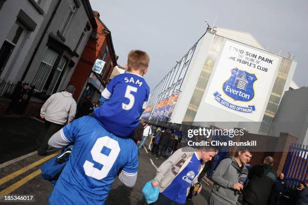 Young fan is given a lift to Goodison Park prior to the Barclays Premier League match between Everton and Hull City at Goodison Park on October 19,...