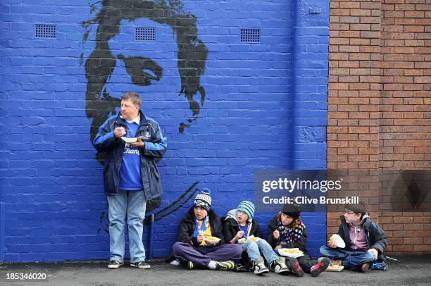 Young children eat fish and chips at Goodison Park prior to the Barclays Premier League match between Everton and Hull City at Goodison Park on...