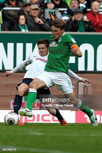 Clemens Fritz of Bremen and Vaclav Pilar of Freiburg compete for the ball during the First Bundesliga match between SV Werder Bremen and SC Freiburg...