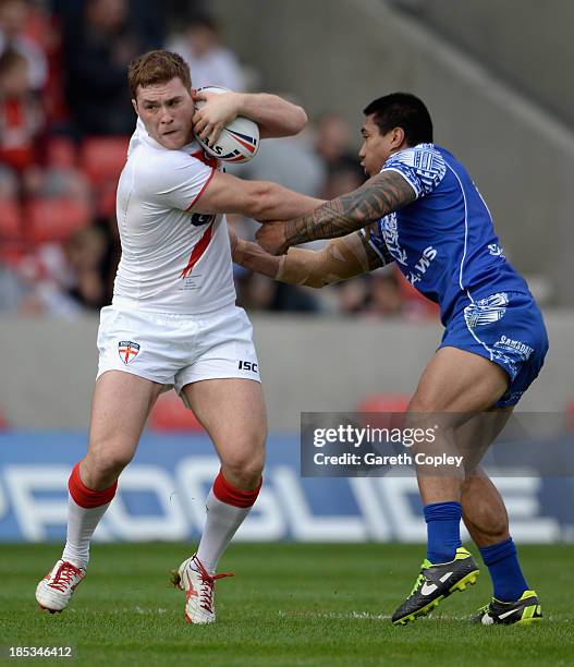 Scott Taylor of England Knights is tackled by David Fa'alogo of Samoa during the International match between England Knights and Samoa at Salford...