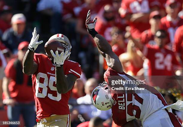 Vernon Davis of the San Francisco 49ers gets past a diving Yeremiah Bell of the Arizona Cardinals to score a touchdown at Candlestick Park on October...