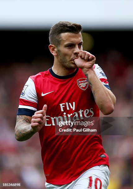 Jack Wilshere of Arsenal celebrates as he scores their first goal during the Barclays Premier League match between Arsenal and Norwich City at...