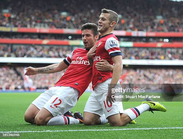 Jack Wilshere celebrates scoring his goal with Olivier Giroud during the match at Emirates Stadium on October 19, 2013 in London, England.