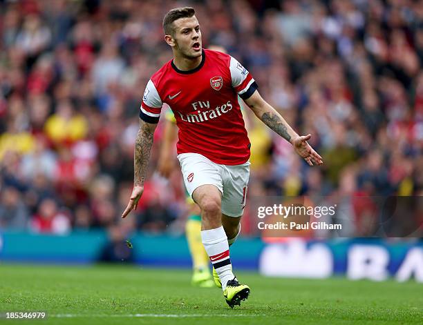 Jack Wilshere of Arsenal celebrates as he scores their first goal during the Barclays Premier League match between Arsenal and Norwich City at...