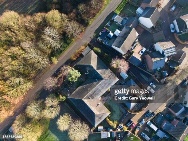 aerial view over housing development in essex countryside on a frosty morning - over abundance stock pictures, royalty-free photos & images