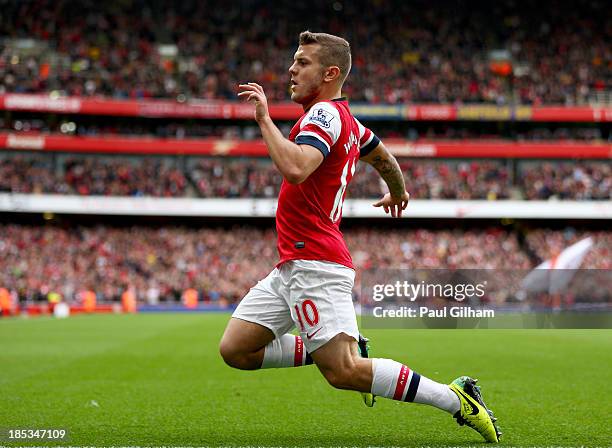 Jack Wilshere of Arsenal celebrates as he scores their first goal during the Barclays Premier League match between Arsenal and Norwich City at...