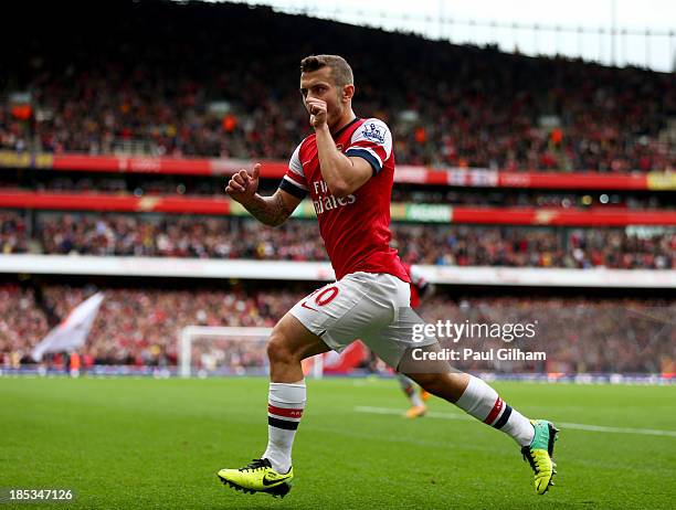 Jack Wilshere of Arsenal celebrates as he scores their first goal during the Barclays Premier League match between Arsenal and Norwich City at...