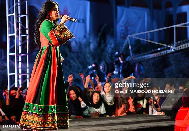Afghan female singer Aryana Sayeed performs during a "Peace Concert" in Babur Garden in Kabul on October 19, 2013. The Taliban, who banned all kind...