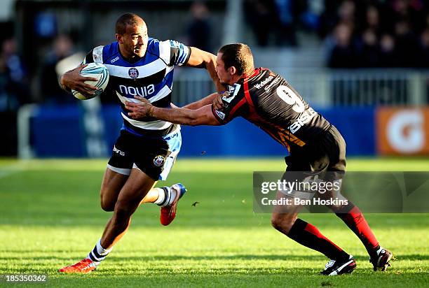 Jonathan Joseph of Bath is tackled by Richie Rees of Newport during the Amlin Challenge Cup match between Bath and Newport Gwent Dragons at...