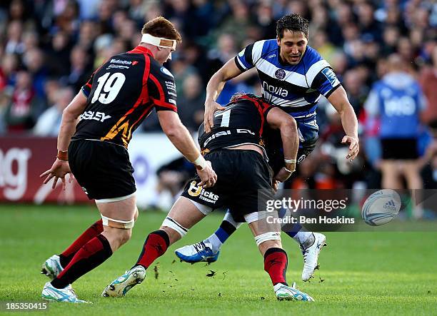 Gavin Henson of Bath loses control of the ball under the tackle of Owen Evans of Newport during the Amlin Challenge Cup match between Bath and...