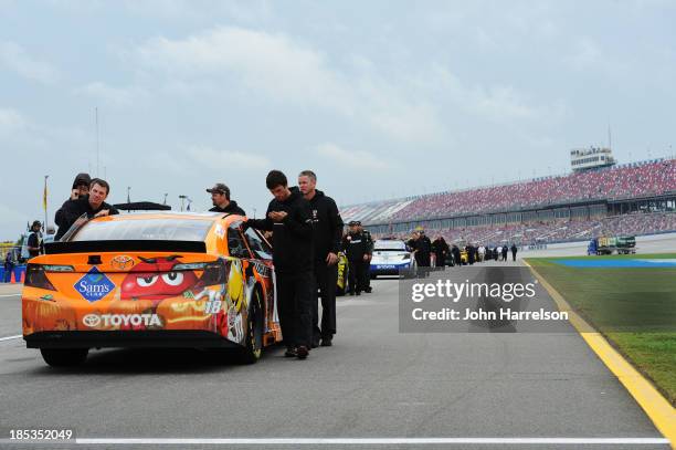 The car of Kyle Busch, driver of the M&M's Halloween Toyota, is pushed back to the garage after qualifying for the NASCAR Sprint Cup Series 45th...