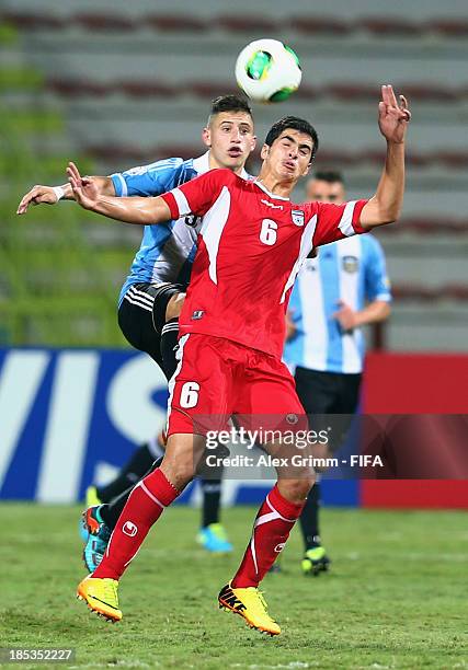 Saeid Ezatolahi of Iran is challenged by German Ferreyra of Argentina during the FIFA U-17 World Cup UAE 2013 Group E match between Iran and...