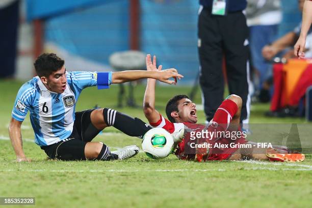 Sadegh Moharrami of Iran is challenged by Leandro Vega of Argentina during the FIFA U-17 World Cup UAE 2013 Group E match between Iran and Argentina...