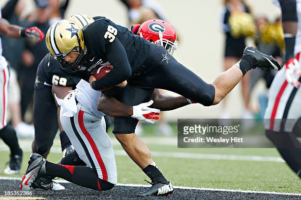 Carey Spear of the Vanderbilt Commodores rushes the ball for a touchdown on a fake field goal during a game against the Georgia Bulldogs at...