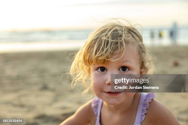 a young girl looking at camera on a beach. - guanacaste beach stock pictures, royalty-free photos & images