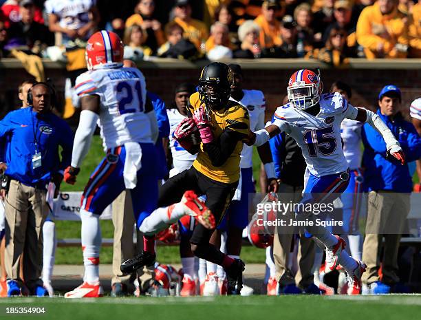 Wide receiver L'Damian Washington of the Missouri Tigers makes a catch as defensive back Jabari Gorman and defensive back Loucheiz Purifoy of the...