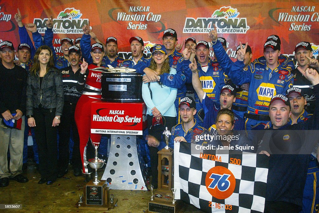 Michael Waltrip holds his wife Buffy as his DEI NAPA Auto Parts crew