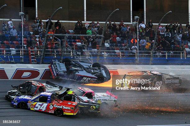 Miguel Paludo, driver of the Duroline Chevrolet, slides down the track on his roof as Darrell Wallace Jr., driver of the Camping World / Good Sam...