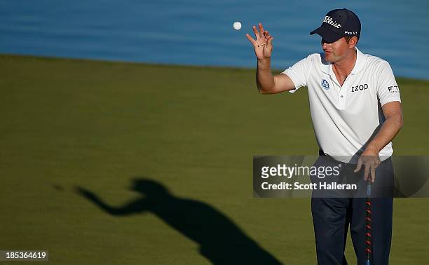 Webb Simpson reaches for his golf ball on the 16th green during the third round of the Shriners Hospitals for Children Open at TPC Summerlin on...