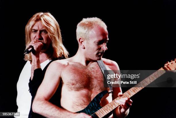 Joe Elliott and Phil Collen of Def Leppard perform on stage at the Birmingham NEC, on October 16th, 1996 in Birmingham, England.