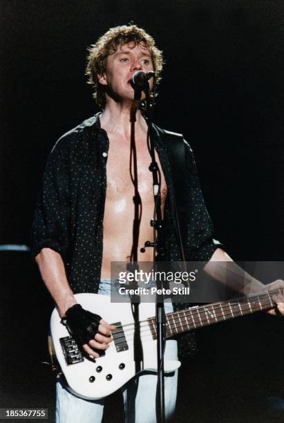 Rick Savage of Def Leppard performs on stage at the Birmingham NEC, on October 16th, 1996 in Birmingham, England.