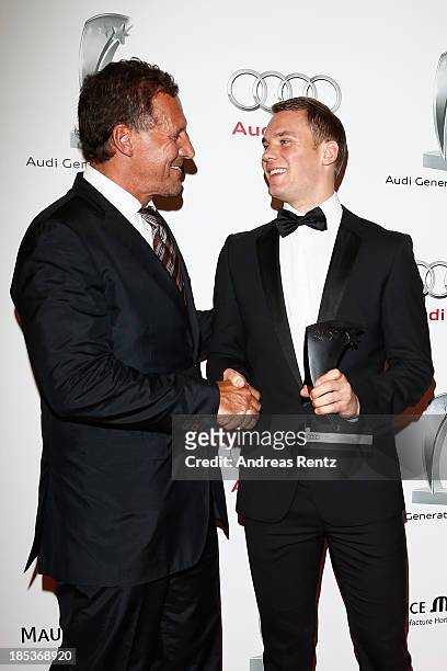 Ralf Moeller and Manuel Neuer with his award attend the 7th Audi Generation Award 2013 at Hotel Bayerischer Hof on October 19, 2013 in Munich,...